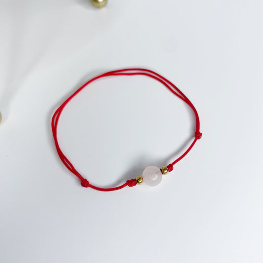 Pulsera de hilo con bola de cuarzo rosa